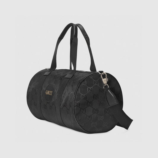Elegant Black Gucci Duffle Bag With Signature GG Pattern And Gold Branding 658632