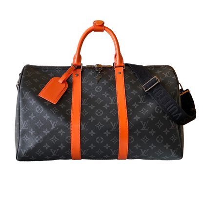 Louis Vuitton Monogram Canvas Travel Bag With Vibrant Orange Accents For Stylish Journeys