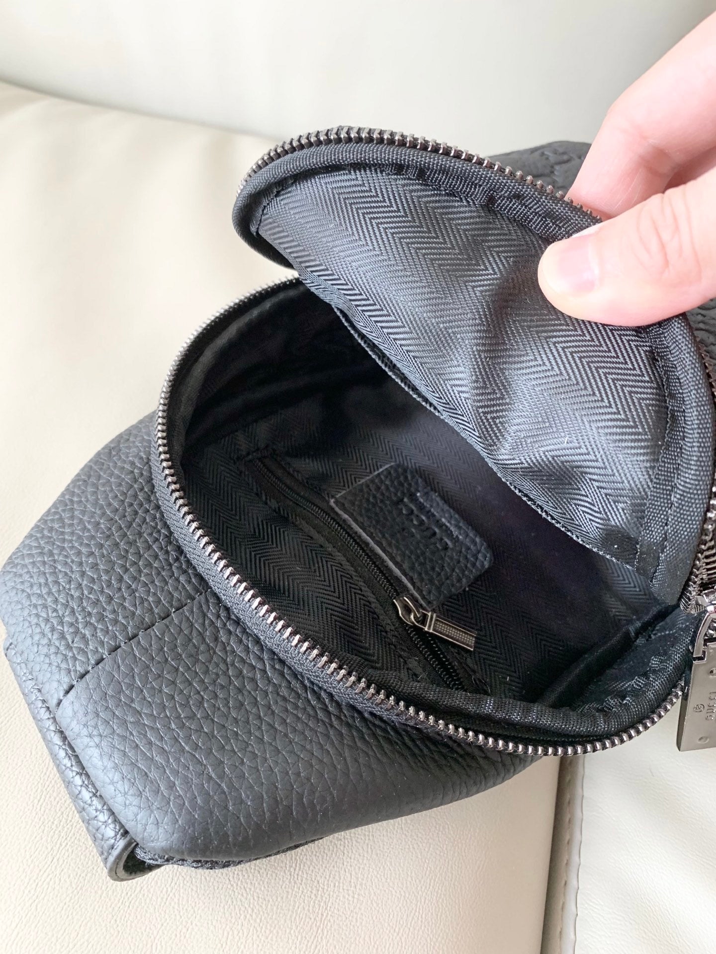 Stylish Black Gucci Sling Bag With Embossed GG Pattern And Brand Detailing For Modern Fashion 3218