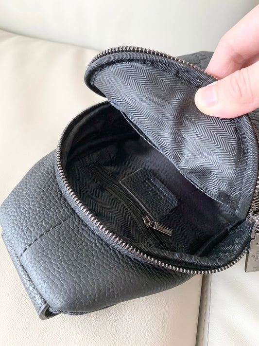 Stylish Black Gucci Sling Bag With Embossed GG Pattern And Brand Detailing For Modern Fashion 3218