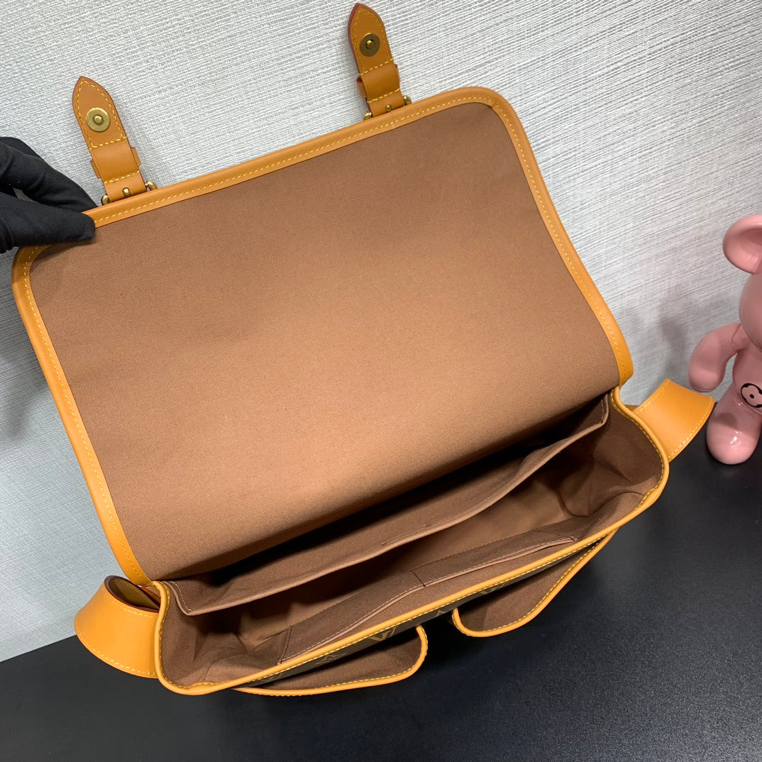 Classic Louis Vuitton Monogram Messenger Bag With Tan Leather Accents And Buckles