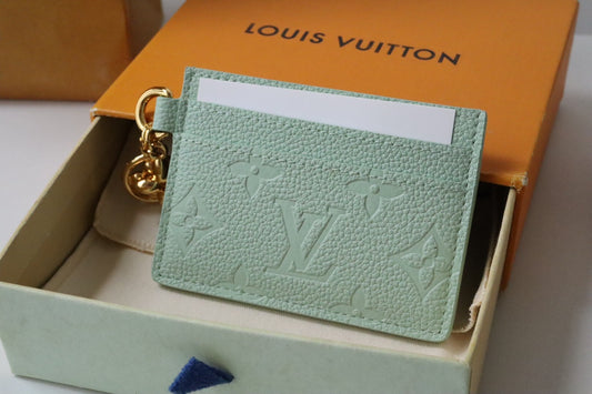 Chic Louis Vuitton Black Embossed Leather Card Holder With Gold Keychain Accent
