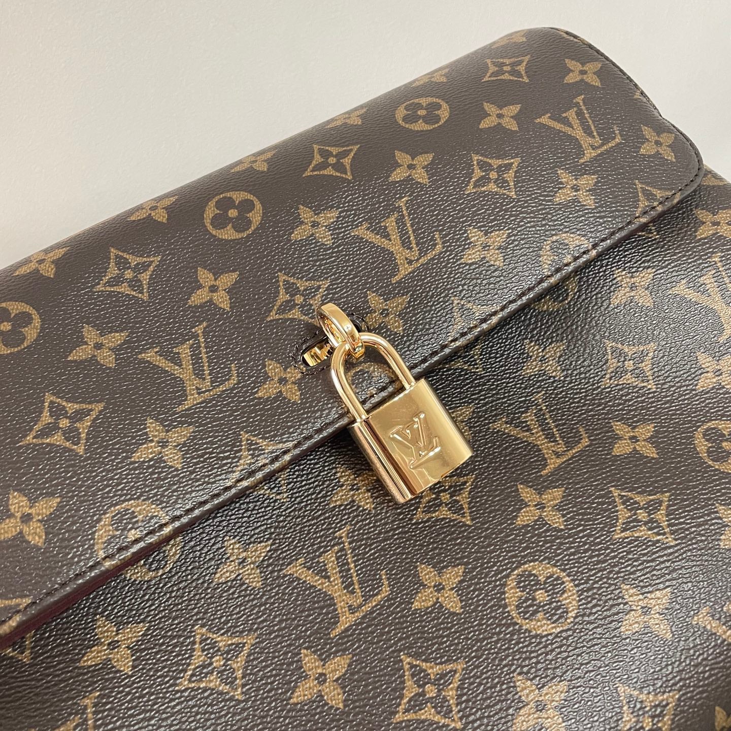 Classic Louis Vuitton Monogram Canvas Handbag With Lock Detail And Stylish Design
