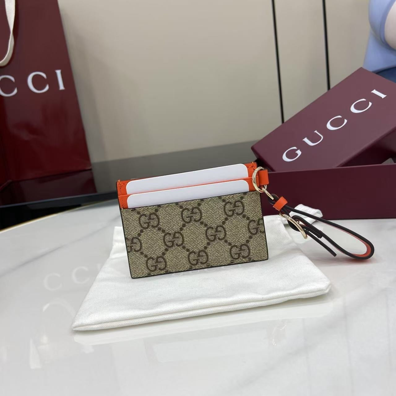 Chic Gucci Card Holder With Signature GG Pattern Orange Accents And Wrist Strap 819121